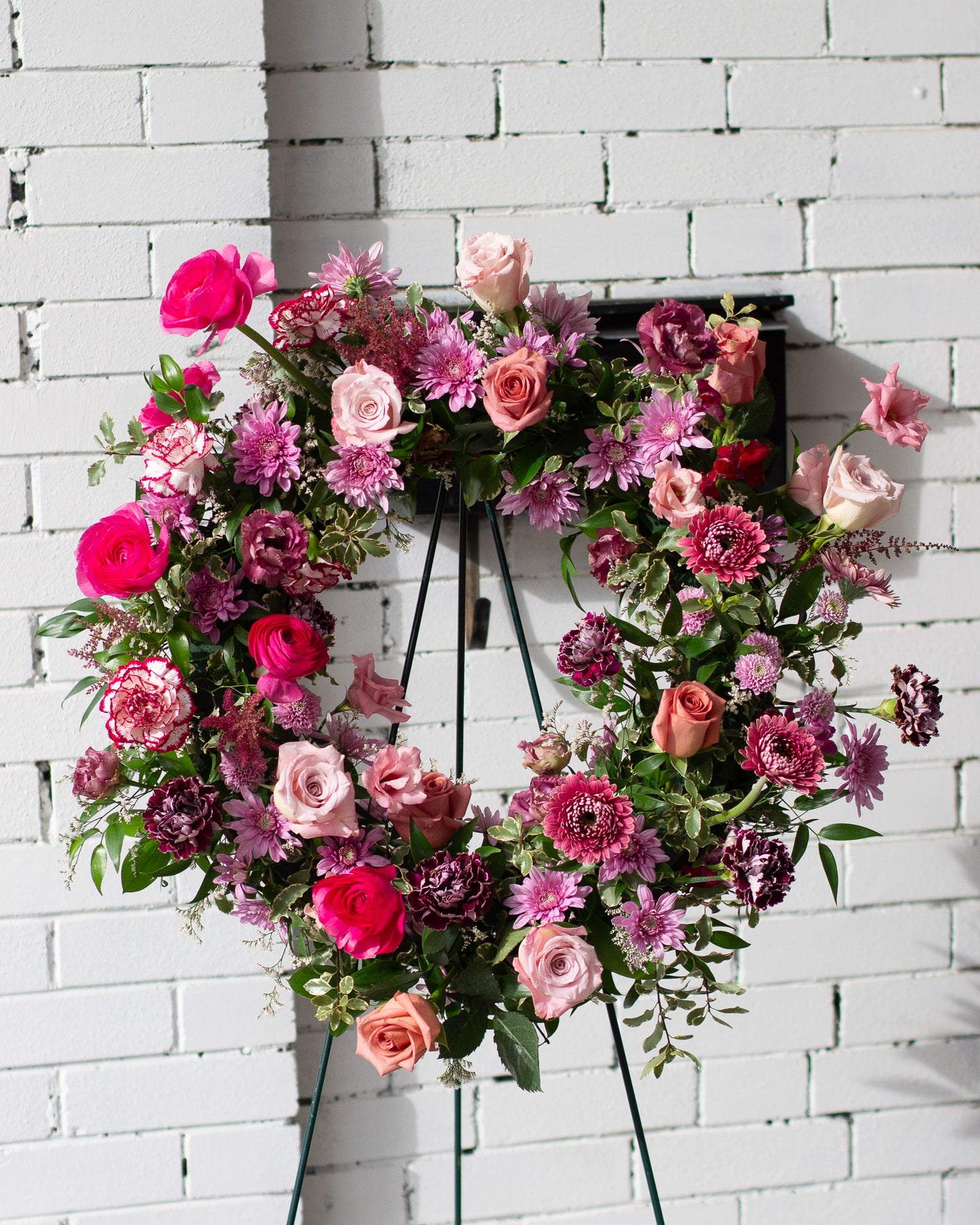 Floral wreath with pink and purple flowers for delivery or pickup in Toronto.