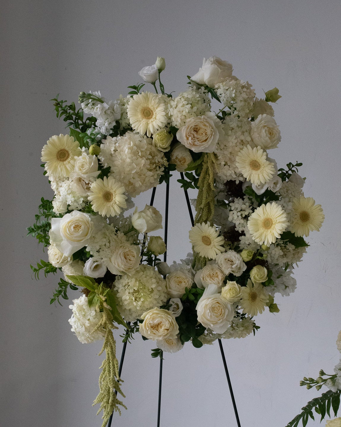 Floral wreath made of white and yellow flowers for delivery or pickup in Toronto.