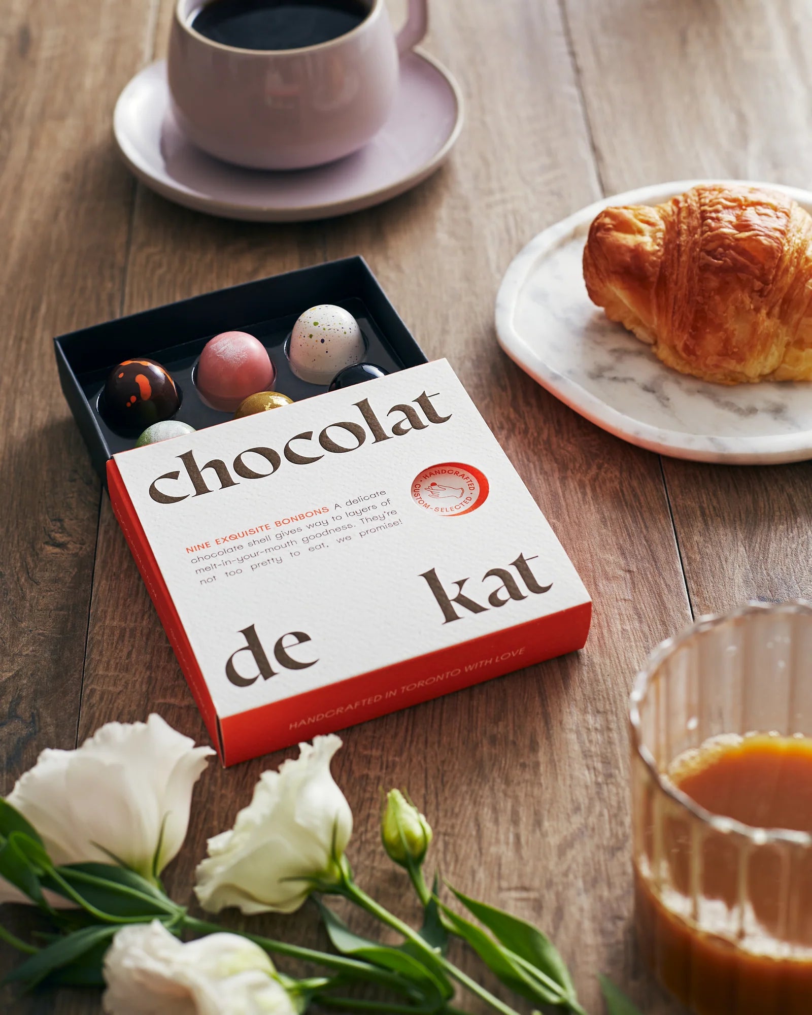 Box of Chocolat de Kat chocolates on a wooden table for delivery or pickup in Toronto.