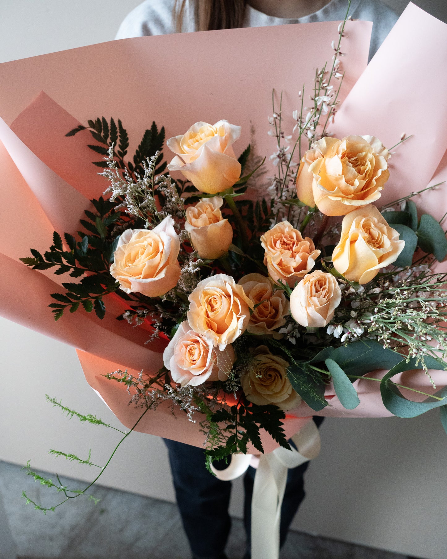 Bouquet of peach-colored roses with greenery for delivery or pickup in Toronto.