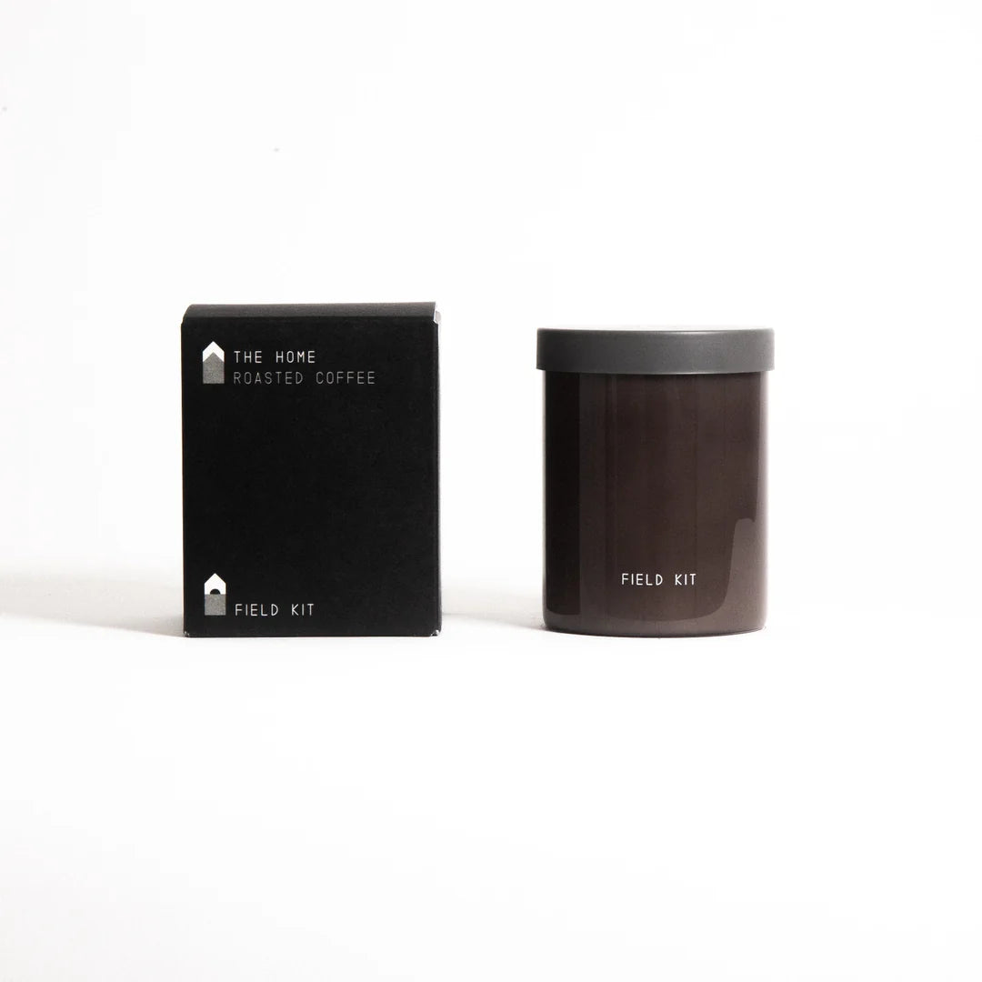 Field Kit home roasted coffee candle in dark glass jar with matching black box, minimalist design