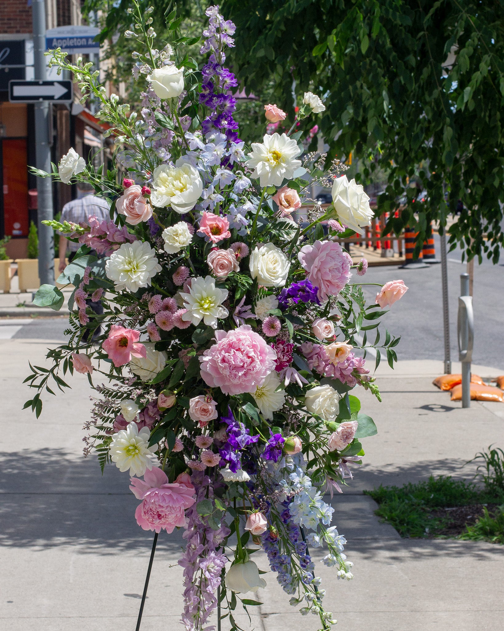 Colorful standing spray floral arrangement for delivery or pickup in Toronto.