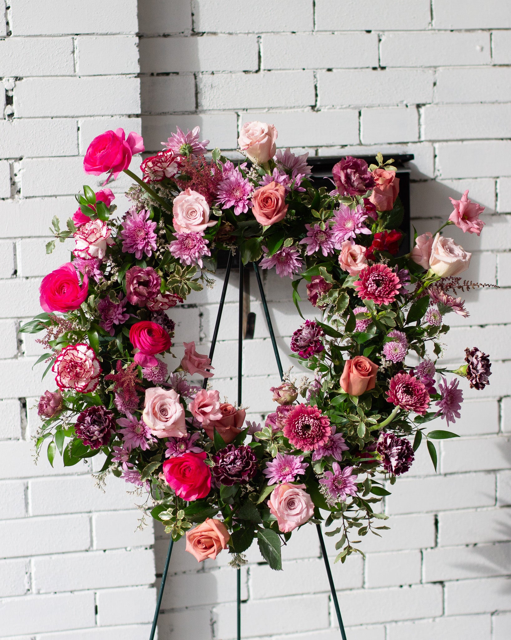 Floral wreath with pink and purple flowers for delivery or pickup in Toronto.