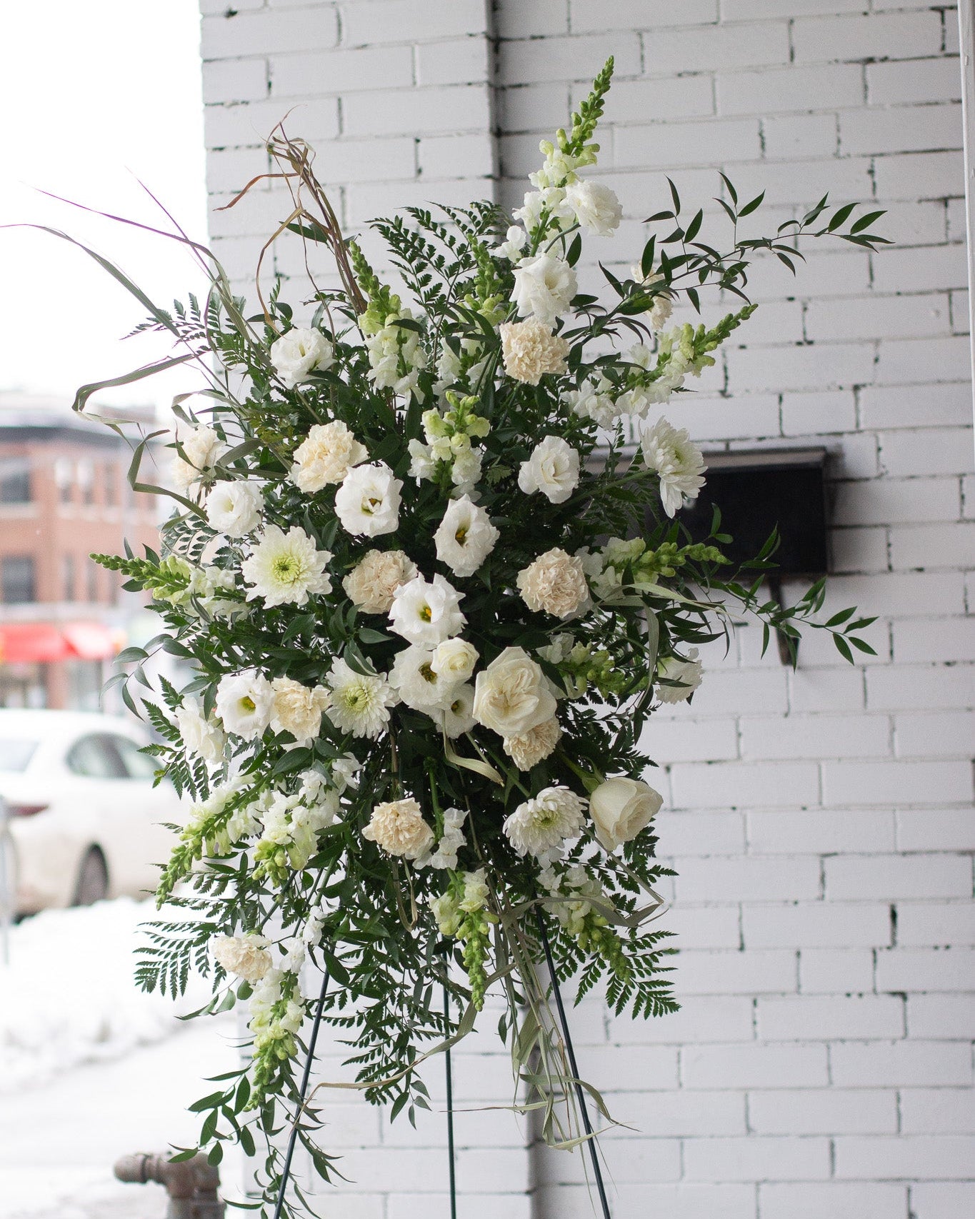 Standing spray white floral arrangement for delivery or pickup in Toronto.