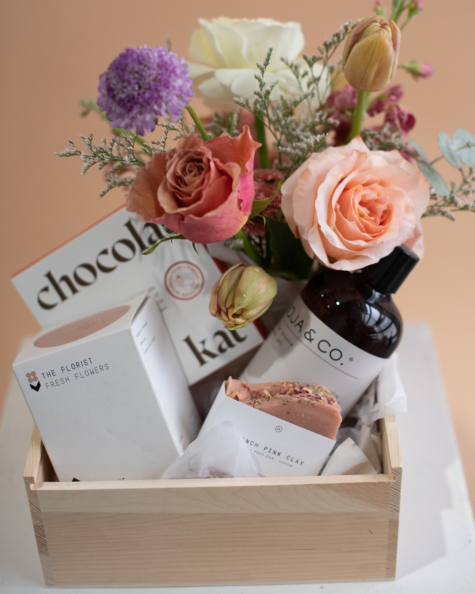 Gift basket with a small vase arrangement, soap, and chocolate bars for delivery or pickup in Toronto.