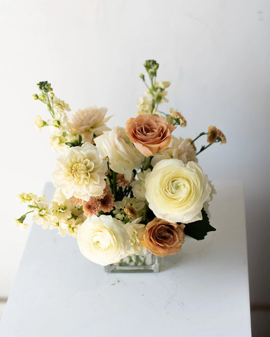 Modern cream and peach floral arrangement in glass vase by Annam Studio Toronto