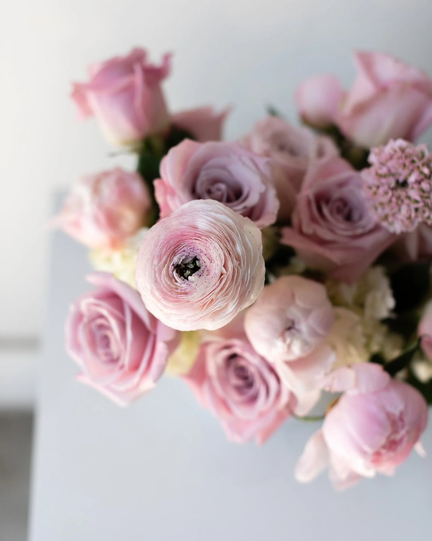 Modern pink rose and ranunculus floral arrangement by Annam Studio Toronto