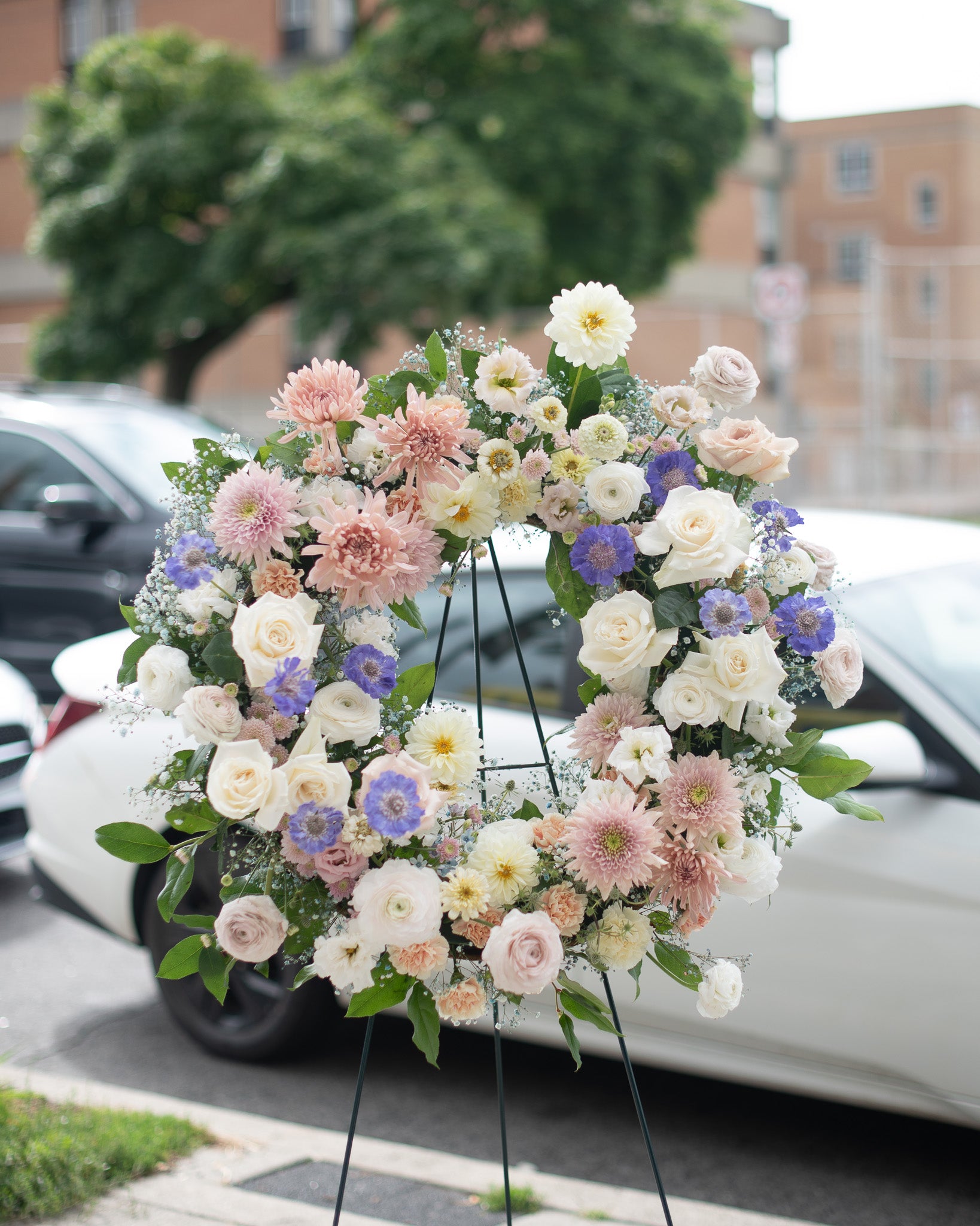 Modern pastel floral wreath by Annam Studio displayed outdoors in Toronto