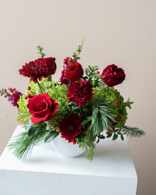 Bouquet of red and green flowers in a white vase for delivery or pickup in Toronto.