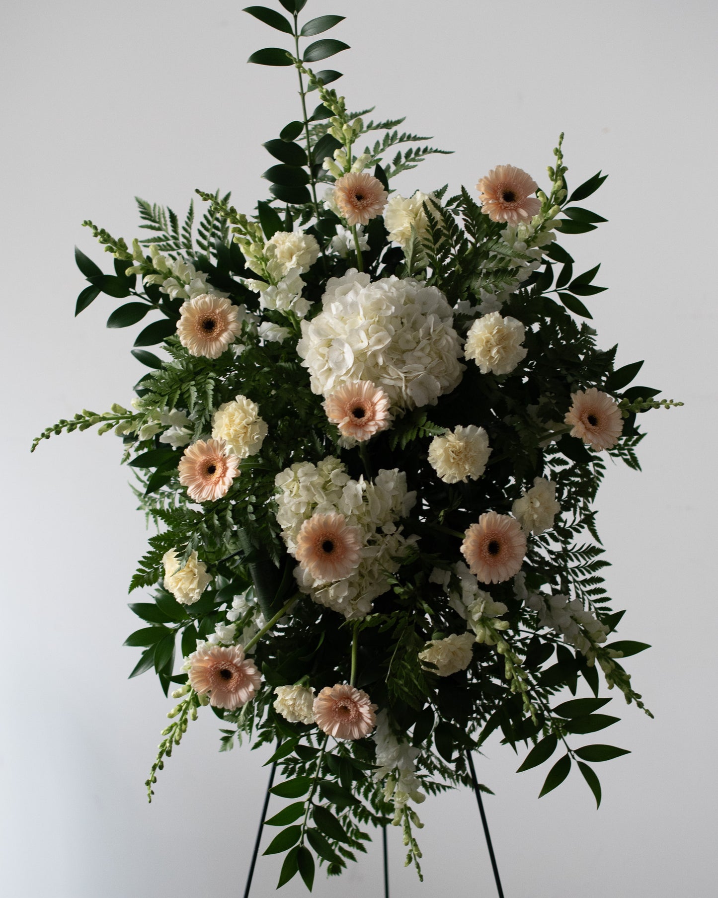Floral arrangement with white and pink flowers on a stand for delivery or pickup in Toronto.