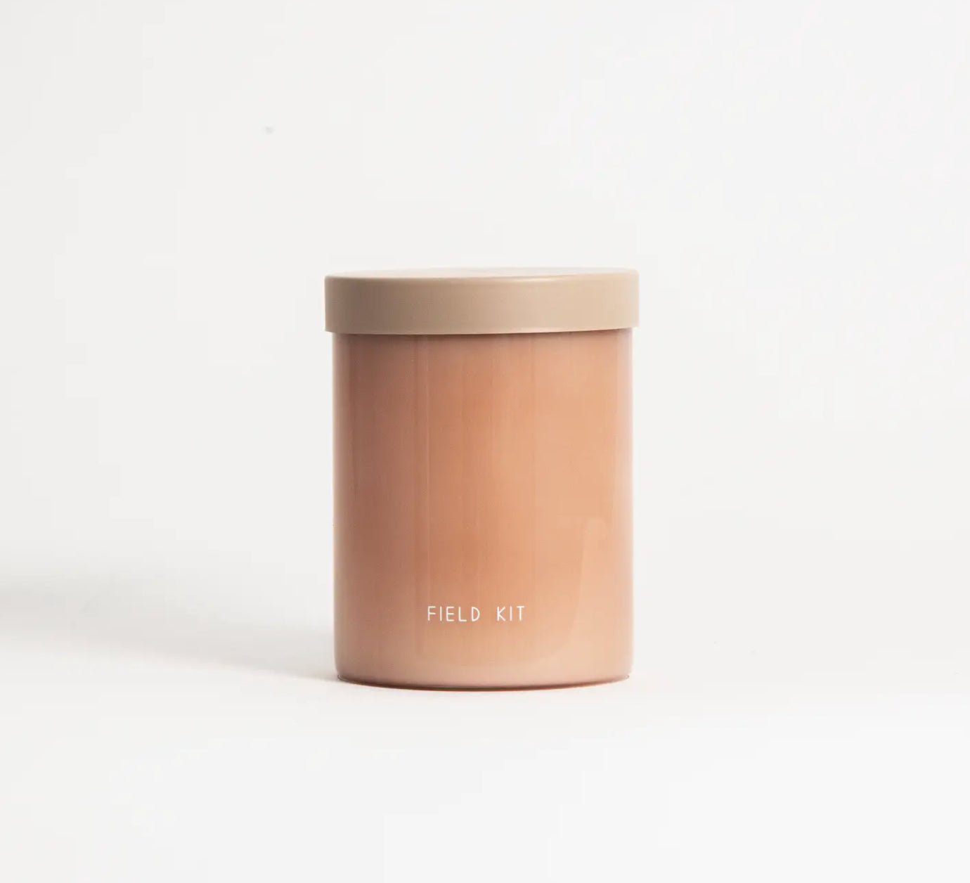 Minimalist beige Field Kit candle jar on white background from Annam Studio Toronto