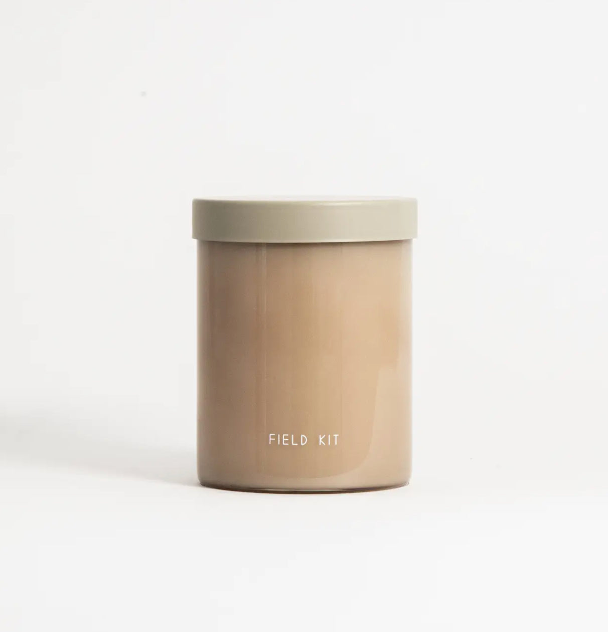 Minimalist beige Field Kit candle jar on white background, available at Annam Studio Toronto