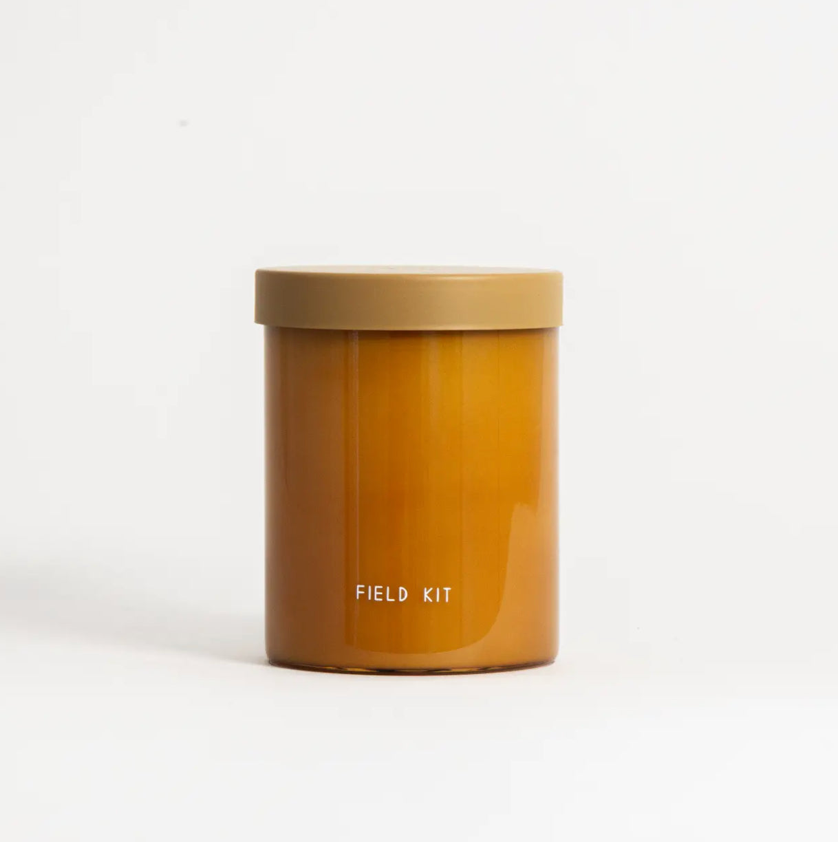 Amber glass Field Kit candle jar on white background, Annam Studio curated gift